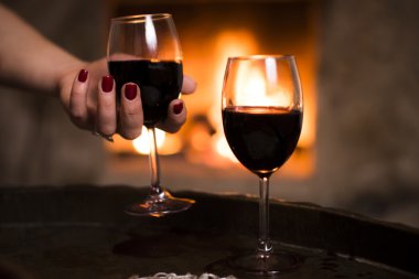 Woman hand holds the wine glass. clipart