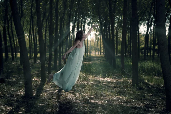 Woman flying in the woods — Stock Photo, Image