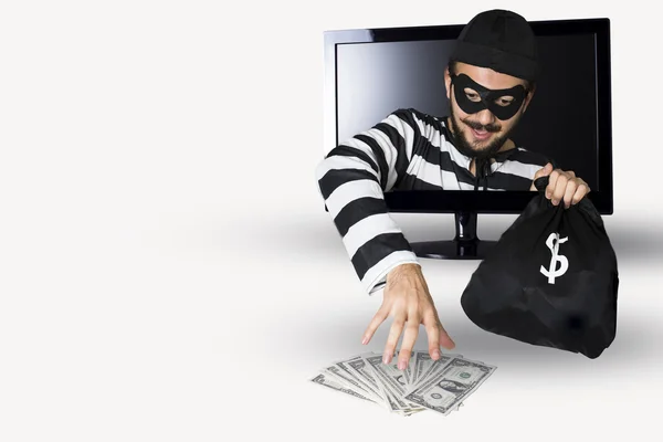 Glückliche Einbrecher stehlen Geld in einem Computermonitor auf weißem Hintergrund. — Stockbild Einbrecher — Stockfoto