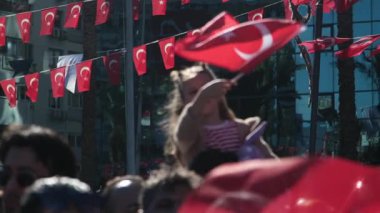 İzmir, Türkiye - 29 Ekim 2025: Kızın babasının omuzlarında Cumhuriyet Günü kutlamalarında Türk bayrağını coşkuyla salladığı yavaş çekim videosu.