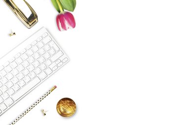 Office desk and woman objects on white table. Flat lay. Tulip , gold stapler, pencil. Table view. Still life of fashion