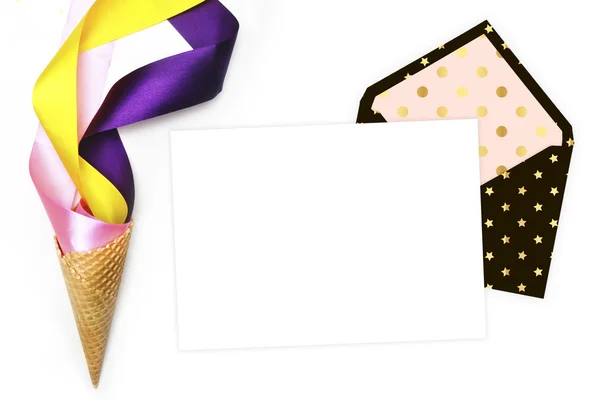 Template invitation with envelope on the table. Flat lay. Party background mockup. Party desktop. Ice scream cone and colored ribbon — Stock Photo, Image
