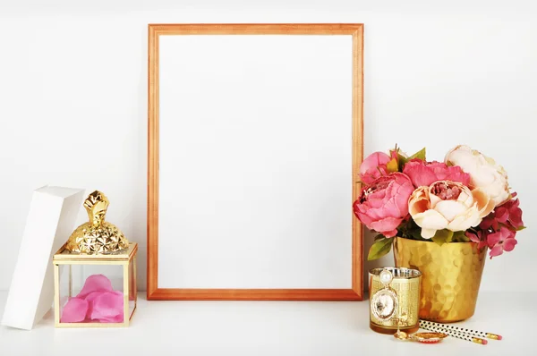 Wood frame with gold vase and gold items. Frame mock-up.