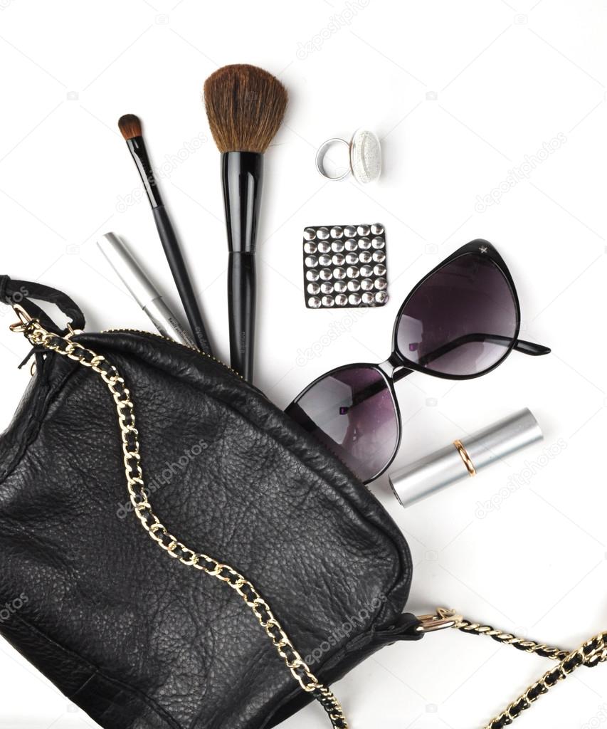 Table view, workspace. Makeup, handbag, brush, lipstick, glasses