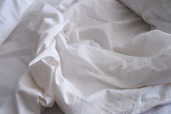 Bed linen texture. White bed linen background. Bed. Interior.