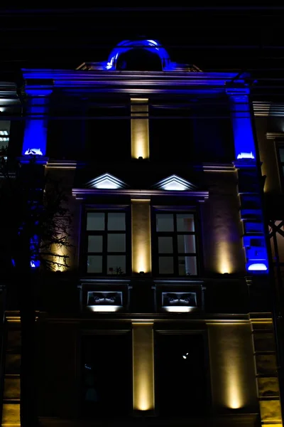 Facade Three Story House Illuminated Blue Yellow Lights Night — Stock Photo, Image