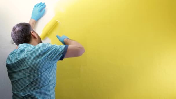 Pintura Mural Hombre Cansado Con Guantes Azules Pinta Amarillo Pared — Vídeo de stock