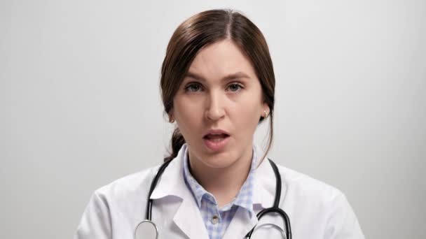 Doctor disagreement, stop, NO says. Frightened worried woman doctor on gray background looking at camera and starts waving her arms nervously, shouting no-no-no. Slow motion — Stock Video