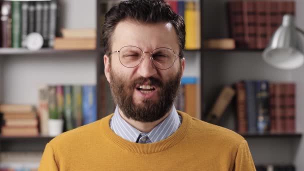 Man disgust, abomination, FU, auch emotion. Bearded male teacher or businessman with glasses looking at camera and his face is distorted in disgust. Slow motion — Stock Video