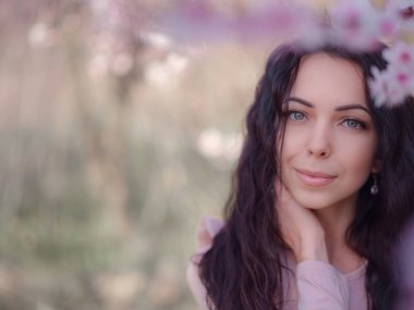 Çiçek açan kiraz ağacının yanında güzel bir genç kadın. Japonya 'daki gibi bahar ve çiçek kutlaması.