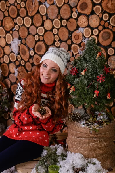 Attractive young woman in a winter fashion shot wearing a wool white cap, a red woolen sweater — Stok fotoğraf