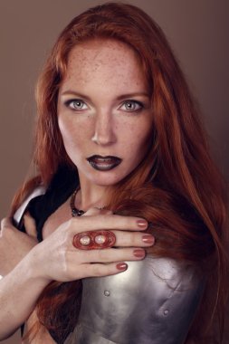 Beautiful red hair girl in knight armour
