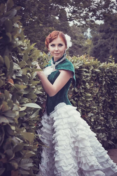 A woman like a princess in an vintage dress in fairy park Stock Photo