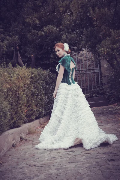 A woman like a princess in an vintage dress in fairy park Stock Photo