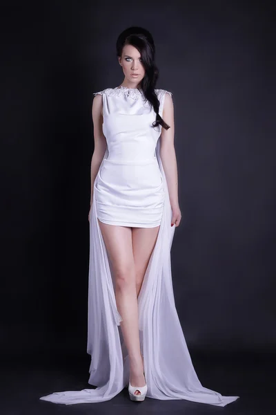 Bride in white nuptial short dress on black background standing — 图库照片