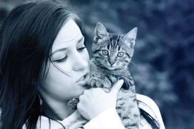 Portrait of the beautiful girl. Sunny winter day. Toned in cold colors