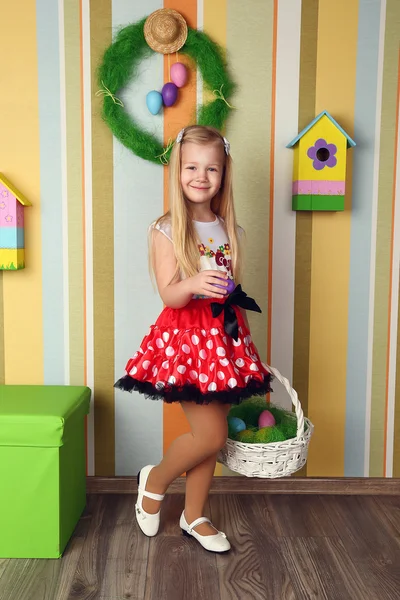 Portrait of a cute little girl dressed in dress  holding colorfu — Stock Photo, Image