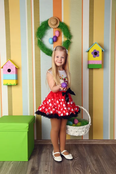 Portrait of a cute little girl dressed in dress holding colorfu — Stock Photo, Image