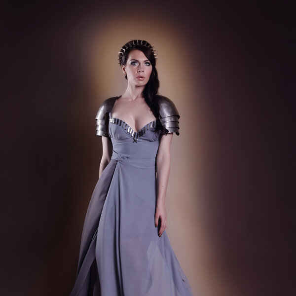 portrait of a beautiful lady warrior, dark-haired girl in a gray