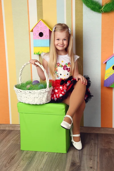 Portrait of a cute little girl dressed in dress  holding colorfu — Stock Photo, Image