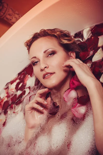 Young woman with red hair take bubble bath with candle. — Stock Photo, Image