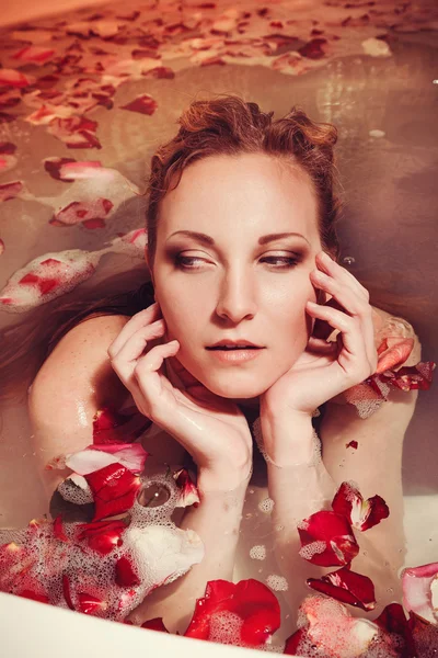 Young woman with red hair take bubble bath with candle. — Stock Photo, Image