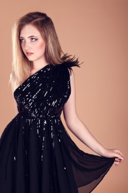 Stüdyoda poz veren güzel genç bir kadın.