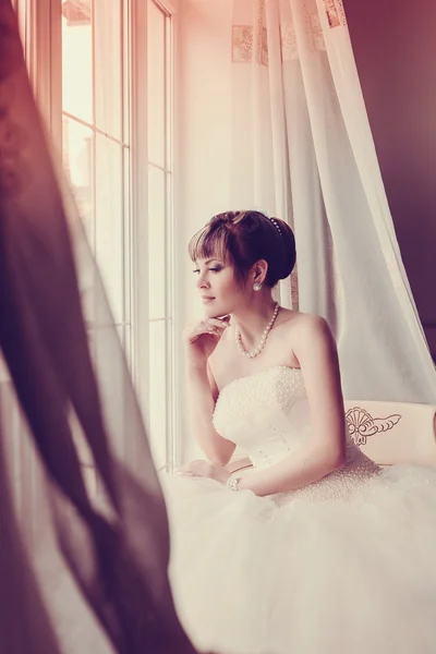 Beautiful young bride with wedding makeup and hairstyle in bedroom, newlywed woman final preparation for wedding. Happy Bride waiting groom. Marriage Wedding day moment. Bride portrait soft focus — Stock Photo, Image