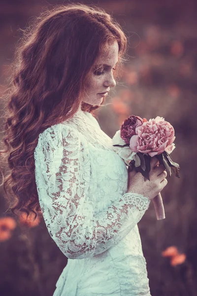 Portrait of young woman in the spring time. Almond flowers blossoms.
