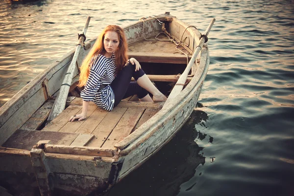 Mulher sexy bonita está vestida com um colete despojado do mar senta-se nos sonhos do litoral . — Fotografia de Stock