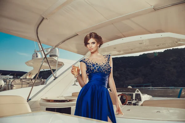 Beautiful young sexy girl in a dress and makeup, summer trip on a yacht with white sails on the sea or ocean — 스톡 사진