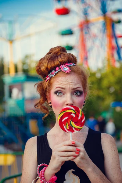 Mooie jonge roodharige vrouw in grappige jurk buiten in amusemen — Stockfoto