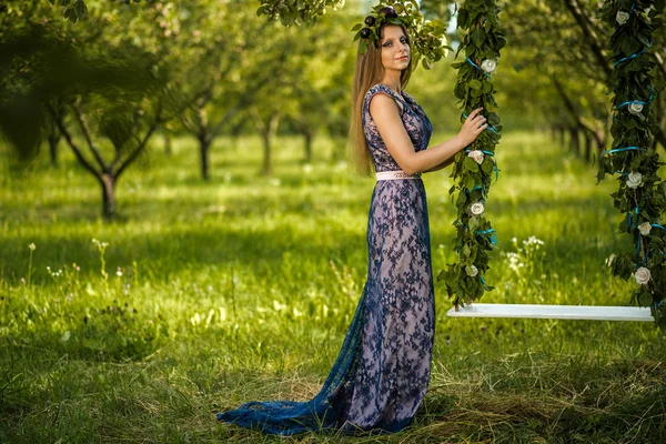 Girl with plums near the swing — Stock Photo, Image