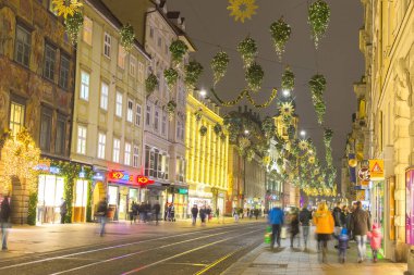 Graz, Avusturya - 18 Aralık 2020: Avusturya 'nın Styria bölgesindeki Graz şehrinde ünlü Herrengasse caddesinde güzel Noel süslemeleri.