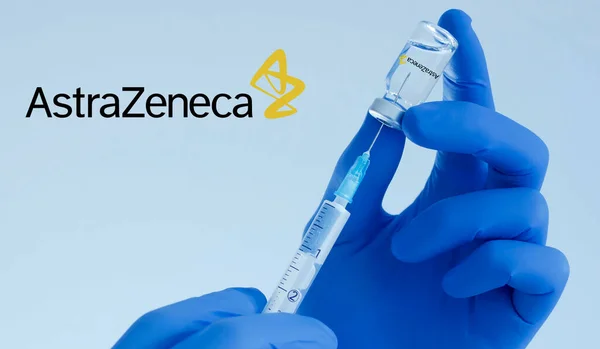 Graz, Austria-26.01.2021: Doctor hands holding a AstraZeneca vaccine bottle and syringe, beginning of mass vaccination for coronavirus COVID-19, world immunization concept