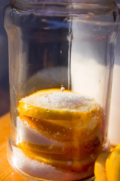 Lemon slices and sugar in a glass jar — Stock Photo, Image