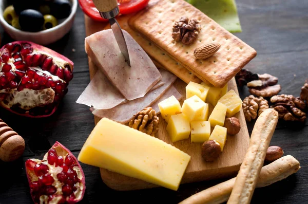 stock image Assorted homemade pieces cheese with honey, fruits, cookies and nuts on table.  Fresh dairy product, healthy organic food. Delicious appetizer.