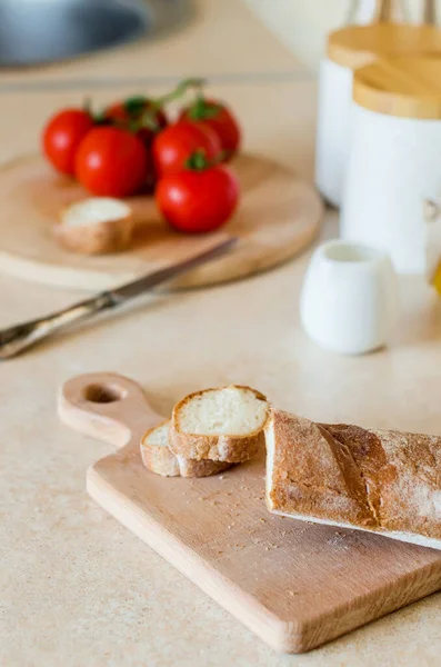 切法式面包 早餐的配料 新鲜的面包和西红柿 背景厨房器皿上的丑闻 有选择的重点 — 图库照片