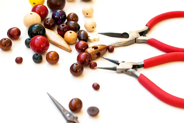 Wooden beads and tools for creating fashion jewelry in the manuf — Stock Photo, Image