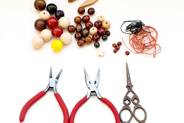 Wooden beads and tools for creating fashion jewelry in the manuf — Stock Photo, Image