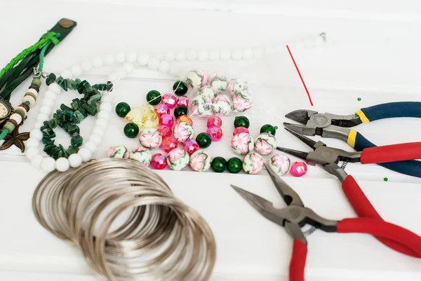 Various beads and tools for making jewelry — Stock Photo, Image