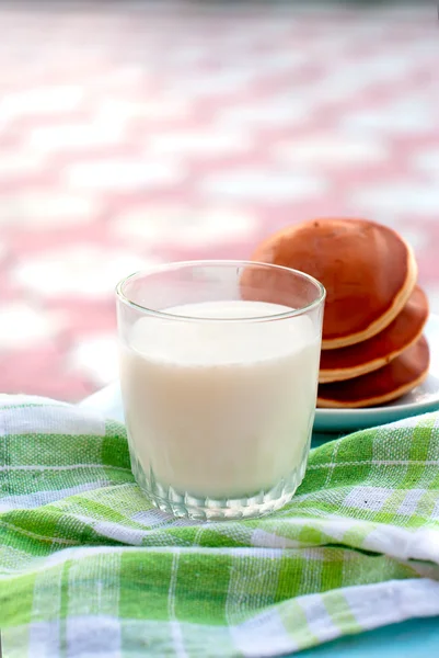 glass of milk and a jug of milk