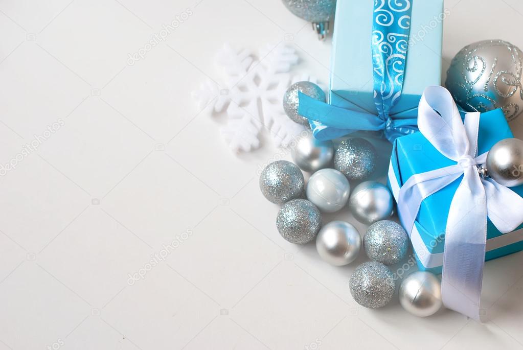 silver Christmas balls and gifts on wooden table