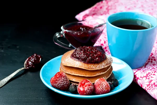 Taza de café y panqueque con salsa de bayas — Foto de Stock