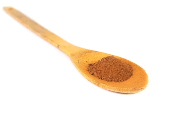 Cinnamon powder on wooden spoon — Stock Photo, Image