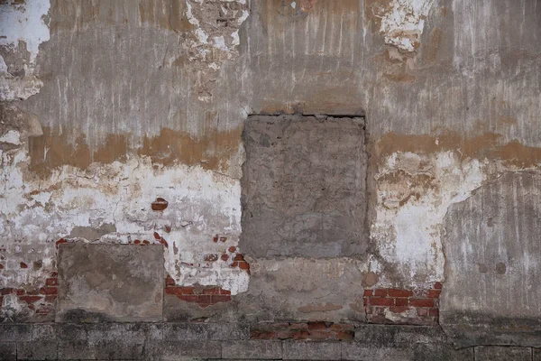 Beton alçılı eski bir tuğla duvar parçası ve çok renkli boya kalıntıları, grunge, arka plan