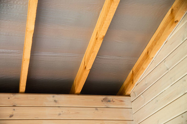 stages of construction of a house made of profiled wooden beams