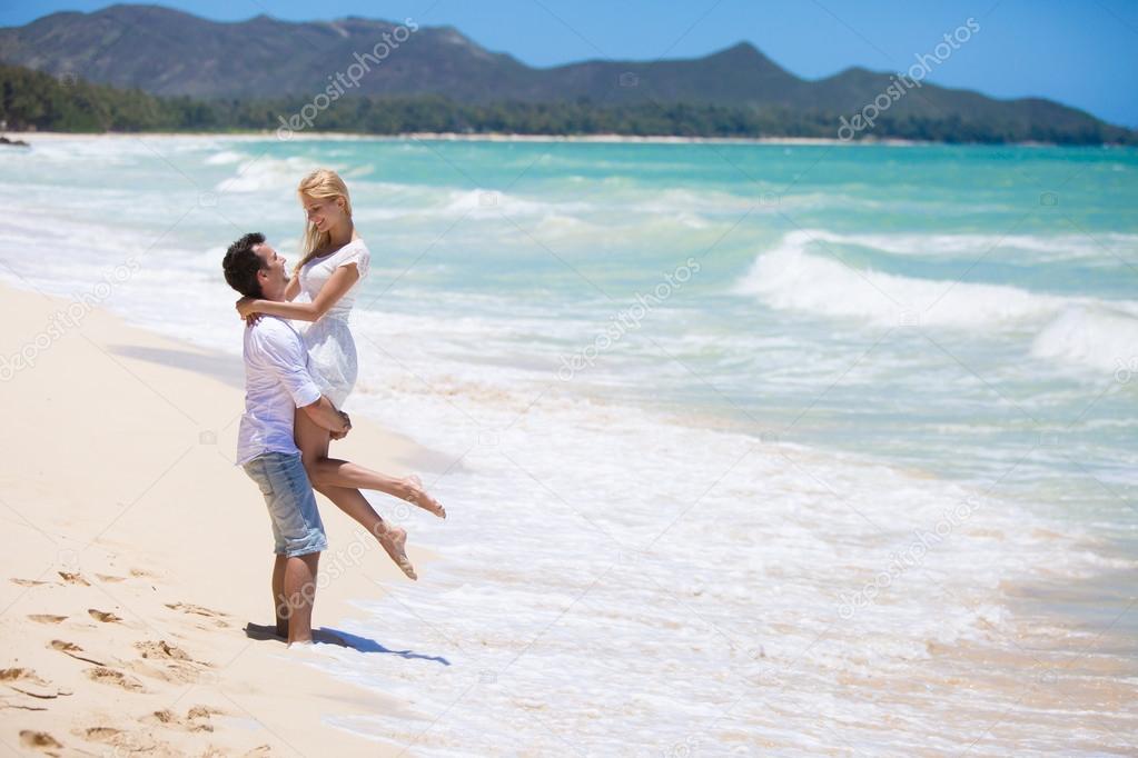 Young couple having fun on a sandy beach