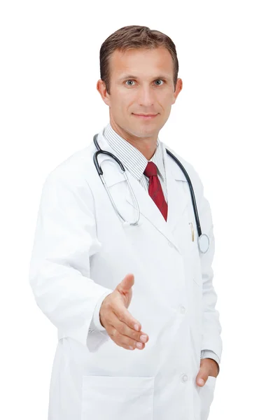 Portrait of smiling male doctor standing against isolated backgr — Stockfoto