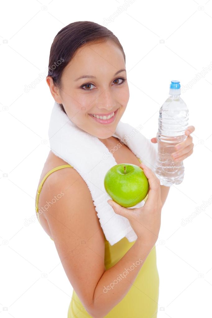 Smiling happy caucasian fitness girl with water bottle and fruit.